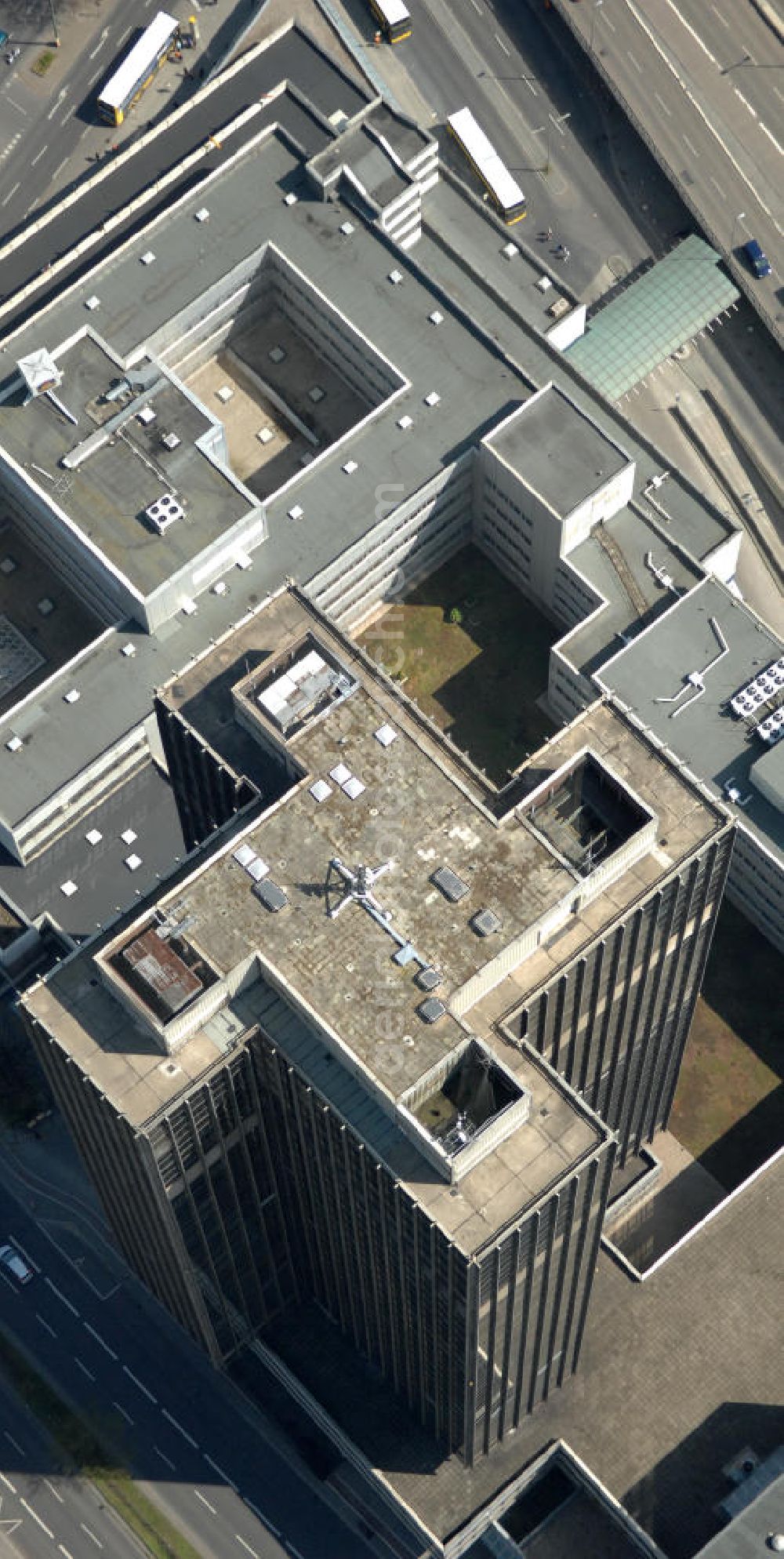 Aerial photograph Berlin - Blick auf den Steglitzer Kreisel , einen Gebäudekomplex mit Bürohochhaus im Berliner Ortsteil Steglitz. 2006 hatte der Berliner Senat beschlossen, das Bürohochhaus aufzugeben und die dort beschäftigten Mitarbeiter des Bezirksamts Steglitz-Zehlendorf in an deren landeseigenen Immobilien unterzubringen. 2007 wurde das Haus geräumt und steht derzeit leer. Die Berliner Finanzverwaltung und der Liegenschaftsfonds hatten vergeblich versucht, das Gebäude im jetzigen Zustand zu verkaufen. Die weitere Nutzung ist ungeklärt, neben dem Verkauf an Wolfgang Gerbere Investoren wird auch ein Abriss nicht ausgeschlossen. View of the Steglitzer Tops, a complex of office tower at the Berlin district of Steglitz.