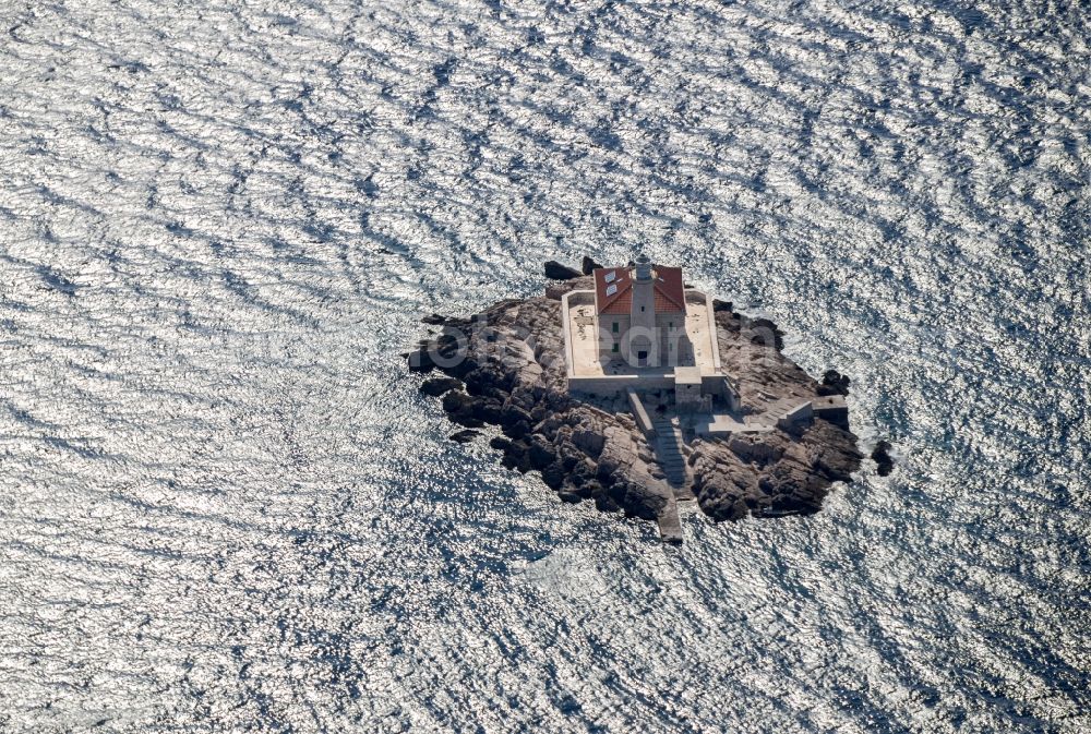 Rogoznica from above - Lighthouse as a historic seafaring character in the coastal area of Otocic Mulo in Rogoznica in Kroatien