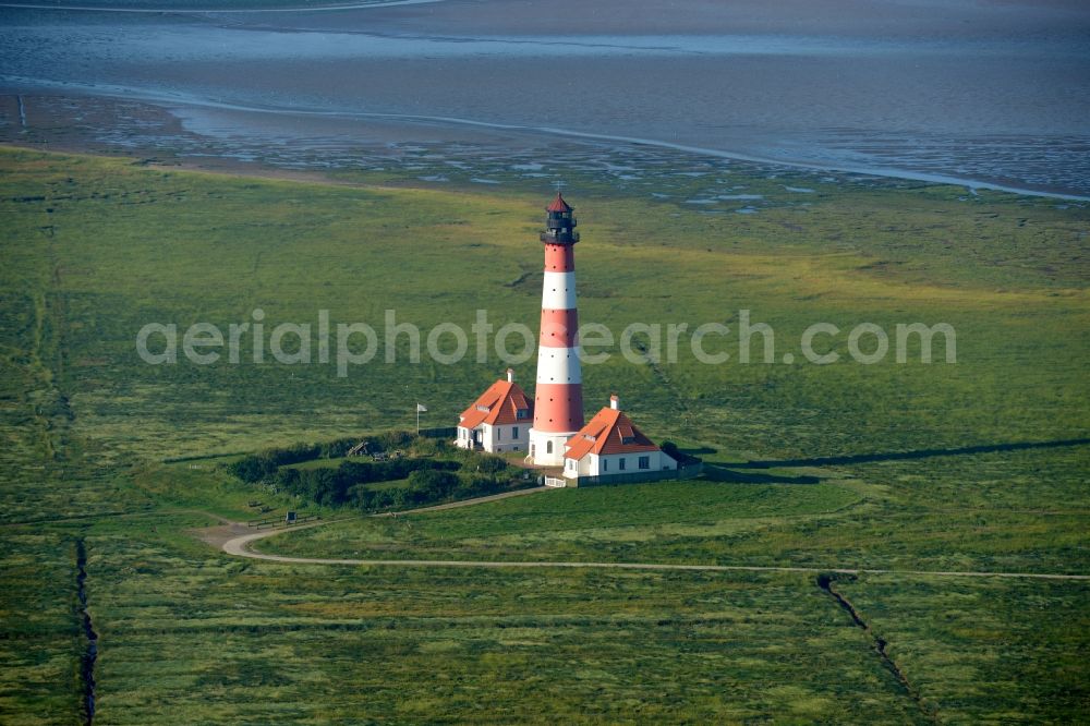 Westerhever from above - Lighthouse as a historic seafaring character in the coastal area of North Sea in the district Hauert in Westerhever in the state Schleswig-Holstein