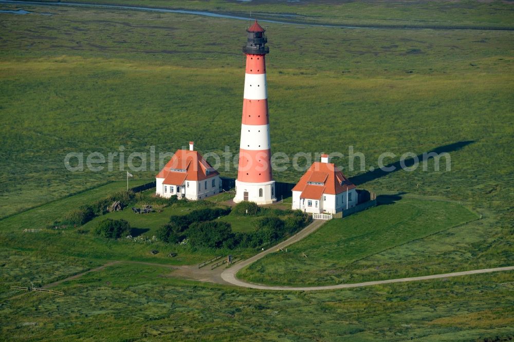 Westerhever from above - Lighthouse as a historic seafaring character in the coastal area of North Sea in the district Hauert in Westerhever in the state Schleswig-Holstein