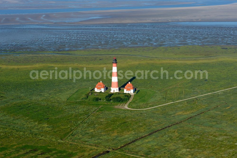 Westerhever from the bird's eye view: Lighthouse as a historic seafaring character in the coastal area of North Sea in the district Hauert in Westerhever in the state Schleswig-Holstein