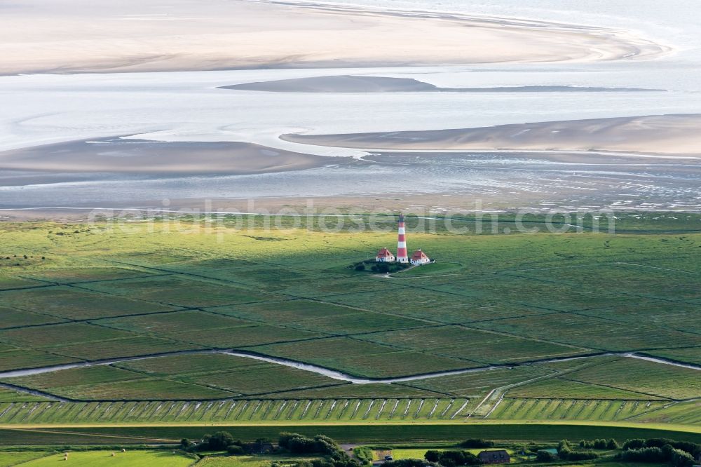 Westerhever from the bird's eye view: Lighthouse as a historic seafaring character in the coastal area of North Sea in the district Hauert in Westerhever in the state Schleswig-Holstein