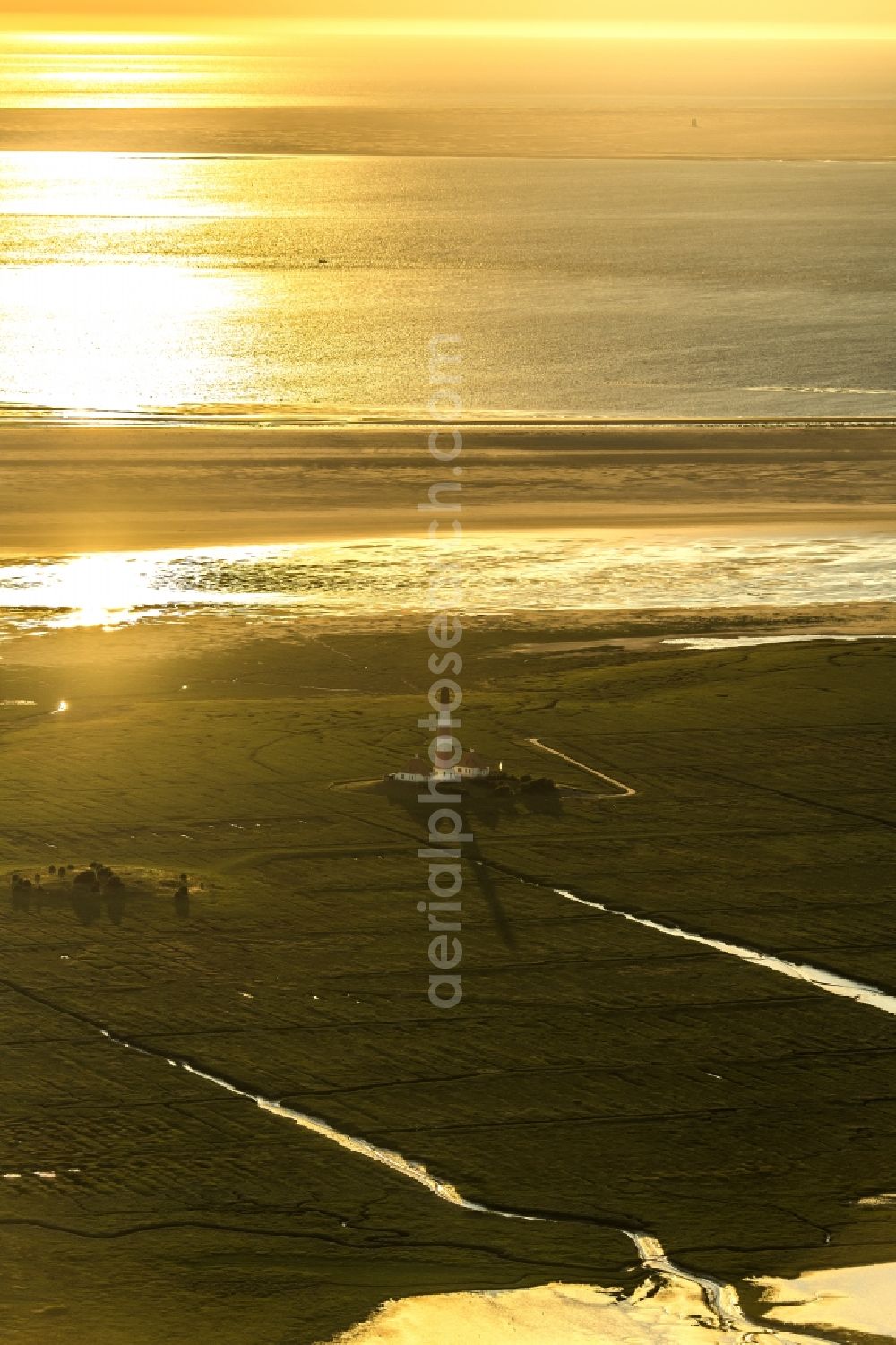 Westerhever from the bird's eye view: Lighthouse as a historic seafaring character in the coastal area of North Sea in the district Hauert in Westerhever in the state Schleswig-Holstein