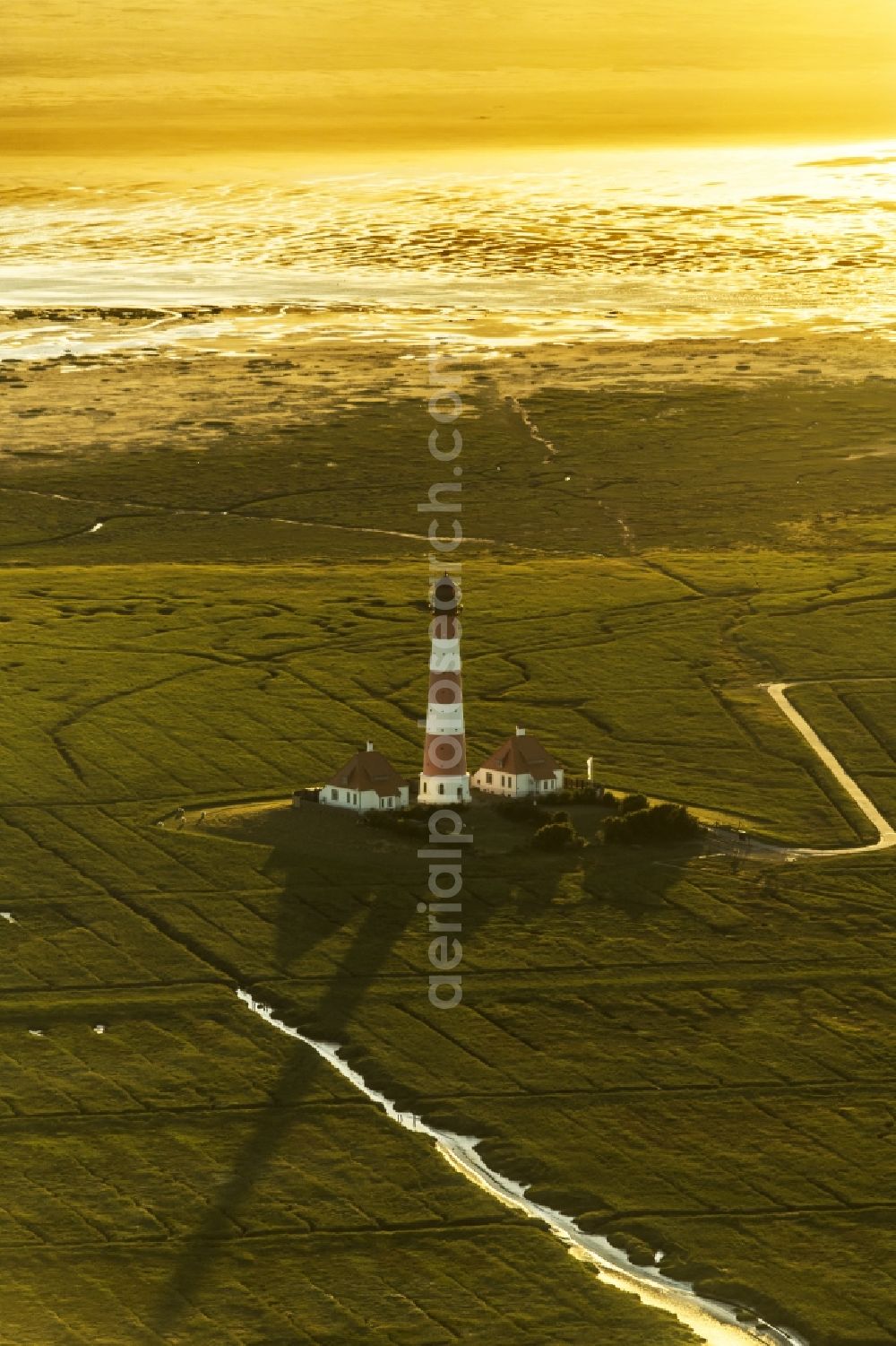 Westerhever from above - Lighthouse as a historic seafaring character in the coastal area of North Sea in the district Hauert in Westerhever in the state Schleswig-Holstein