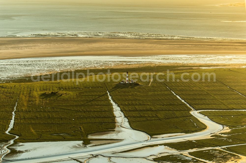 Westerhever from the bird's eye view: Lighthouse as a historic seafaring character in the coastal area of North Sea in the district Hauert in Westerhever in the state Schleswig-Holstein