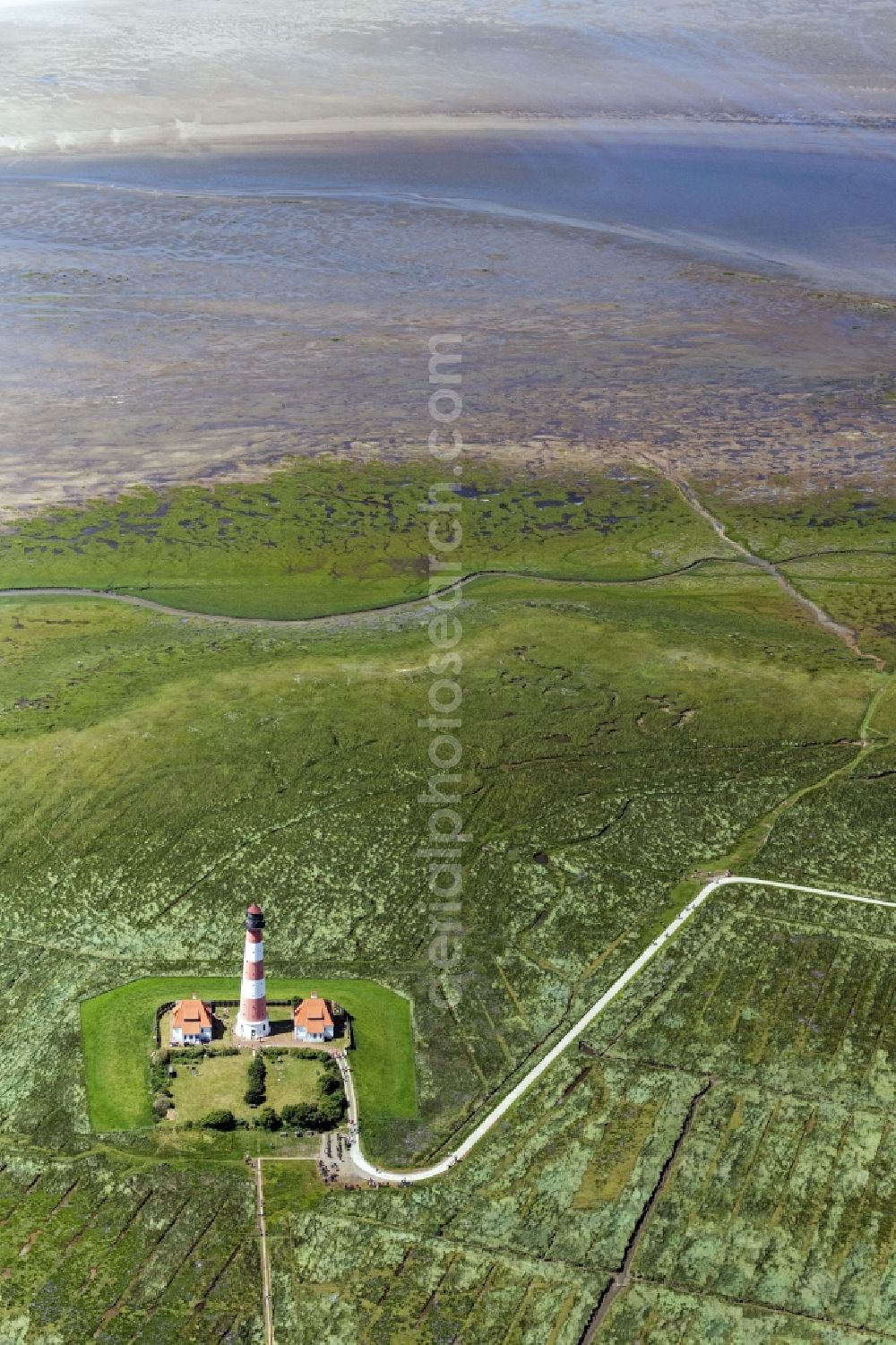 Westerhever from the bird's eye view: Lighthouse as a historic seafaring character in the coastal area of North Sea in the district Hauert in Westerhever in the state Schleswig-Holstein