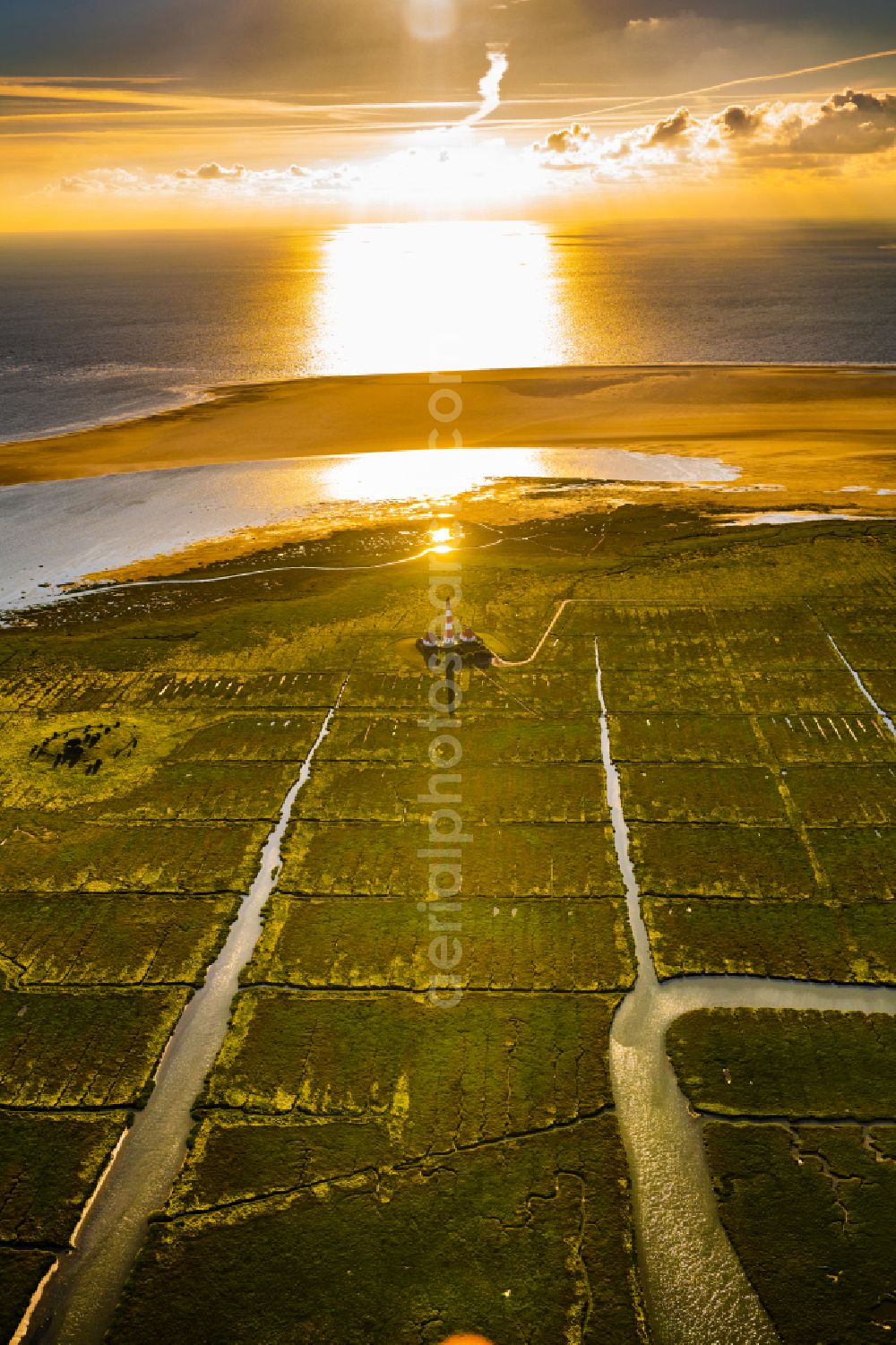 Westerhever from the bird's eye view: Lighthouse as a historic seafaring character in the coastal area of North Sea in the district Hauert in Westerhever in the state Schleswig-Holstein