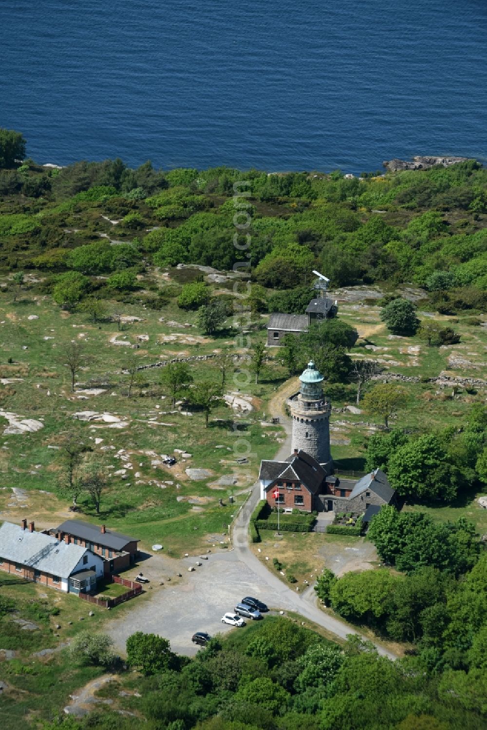 Allinge from above - Lighthouse as a historic seafaring character in the coastal area of Baltic Sea on Bornholm Island in Allinge in Region Hovedstaden, Denmark