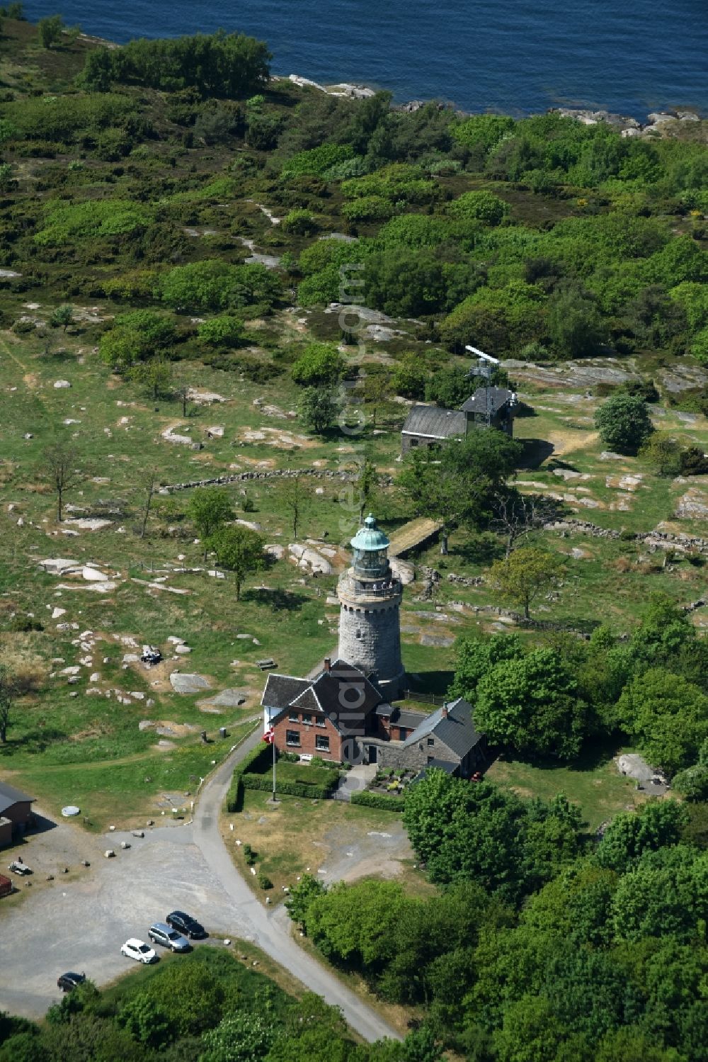 Allinge from the bird's eye view: Lighthouse as a historic seafaring character in the coastal area of Baltic Sea on Bornholm Island in Allinge in Region Hovedstaden, Denmark