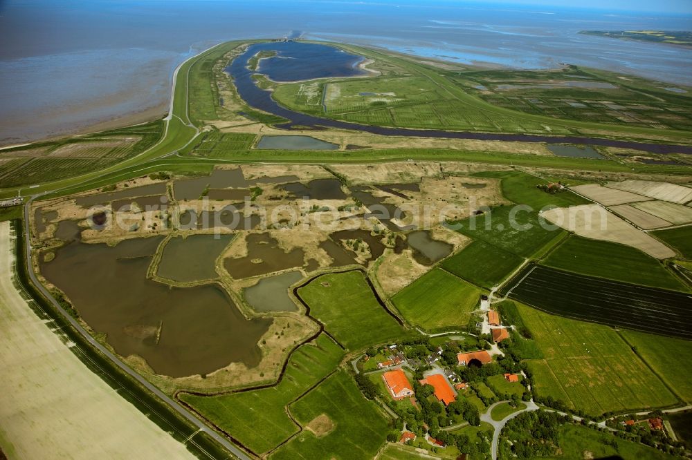 Aerial image Krummhörn - Bay of Ley and the coast at Greetsiel in the borough Krummhoern in the state of Lower Saxony. The village of Greetsiel is located directly in the small bay on the East Frisian west coast. There are several embankments, a flood pool, fields and wetlands - which belong to the Wadden Sea - inside the bay