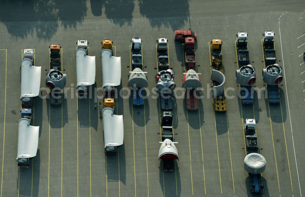 Aurich from the bird's eye view: Lorries freight loaded with components of a wind turbine on the ground of ENERCON GmbH in Aurich in the state Lower Saxony