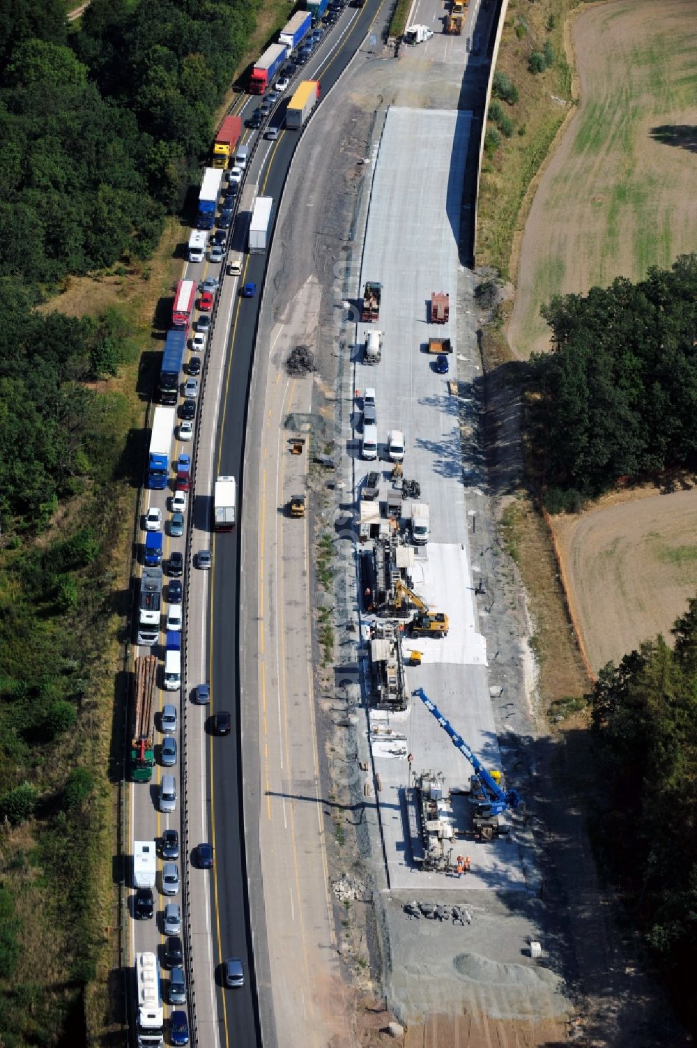 Triptis from above - Buildings and route of the motorway A9 motorway with four lanes now. Currently, reconstruction, expansion and new construction work is underway for the six-lane expansion of Highway 9 between Triptis and Schleiz by Wayss & Freytag Ingenieurbau and EUROVIA VINCI in Thuringia