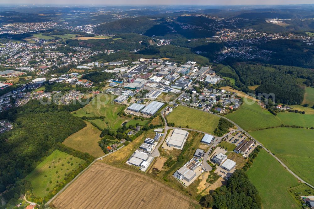 Ennepetal from the bird's eye view: Industrial and commercial area on the edge of agricultural fields and fields in Ennepetal in the state North Rhine-Westphalia, Germany