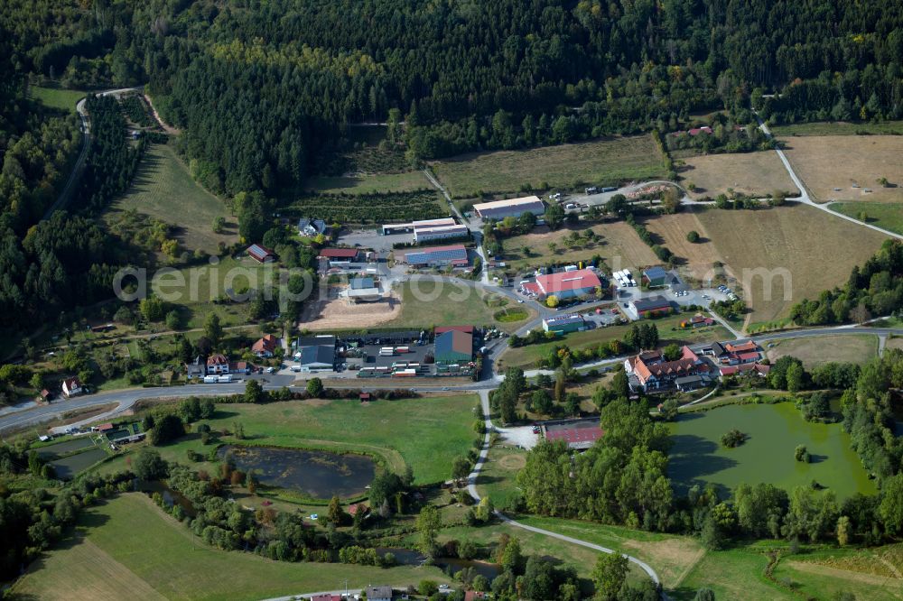 Rieneck from above - Industrial and commercial area on the edge of agricultural fields and fields in Rieneck in the state Bavaria, Germany