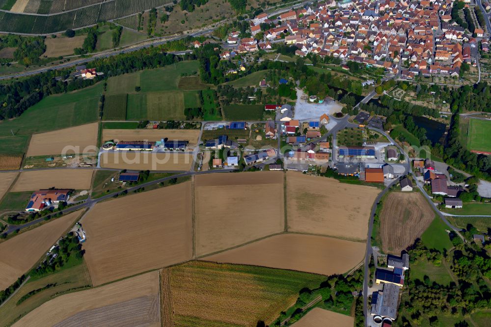 Röttingen from above - Industrial and commercial area on the edge of agricultural fields and fields in Röttingen in the state Bavaria, Germany