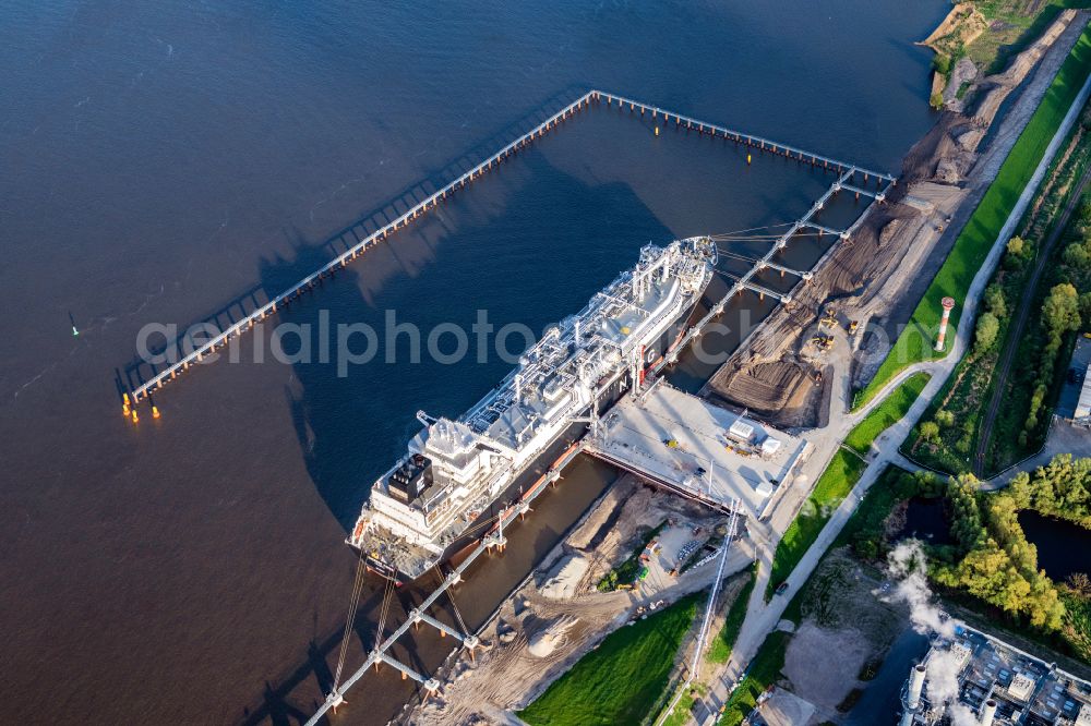 Stade from the bird's eye view: Water bridge with pipeline systems of the LNG natural gas and liquid gas terminal and unloading quay with the special ship Energos Force (formerly Transgas Force) docking on the banks of the Elbe in the district of Buetzfleth in Stade in the state Lower Saxony, Germany