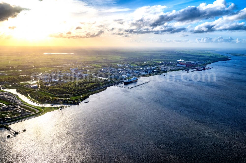 Aerial image Stade - Water bridge with pipeline systems of the LNG natural gas and liquid gas terminal and unloading quay with the special ship Energos Force (formerly Transgas Force) docking on the banks of the Elbe in the district of Buetzfleth in Stade in the state Lower Saxony, Germany