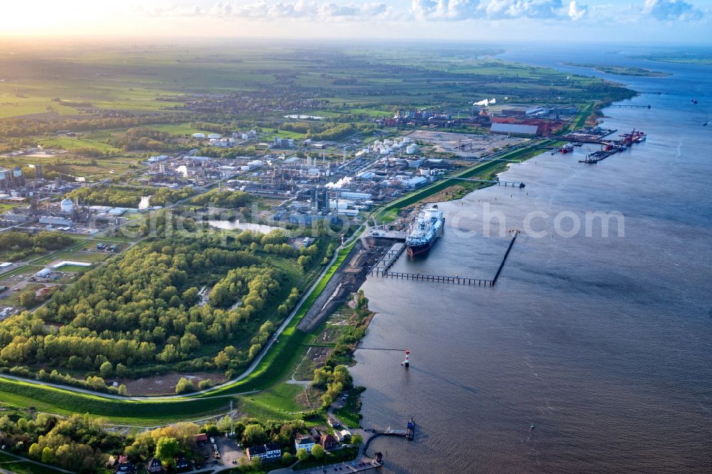 Stade from the bird's eye view: Water bridge with pipeline systems of the LNG natural gas and liquid gas terminal and unloading quay with the special ship Energos Force (formerly Transgas Force) docking on the banks of the Elbe in the district of Buetzfleth in Stade in the state Lower Saxony, Germany