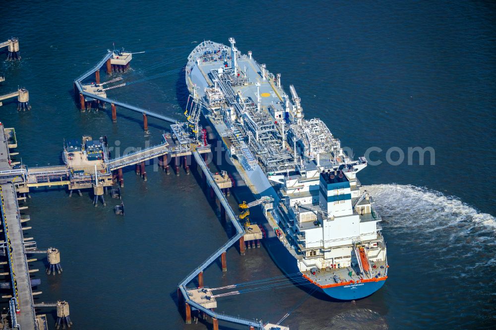 Wangerland from above - Water bridge with line systems of the LNG natural gas and liquid gas terminal and unloading dock when unloading the Hoeegh Esperanza an LNG storage and evaporation ship in Hooksiel in the state Lower Saxony, Germany