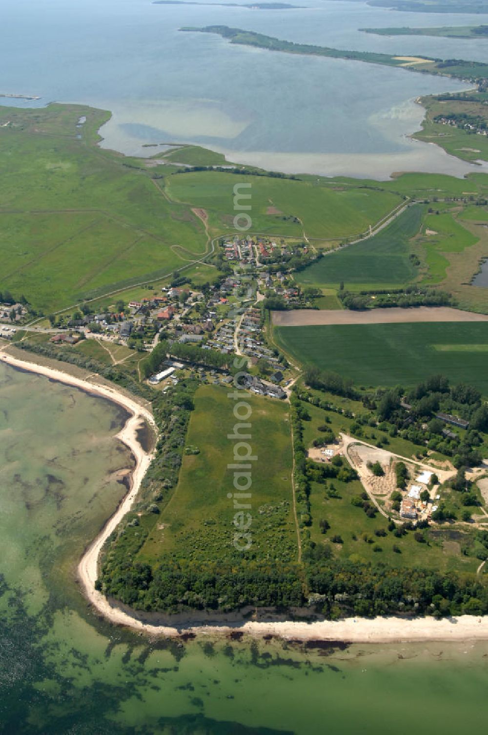 Aerial photograph Lobbe - Blick über die Stadt Lobbe an der Ostsee auf Felder im Biosphärenreservat Südost Rügen und den Rügischen Bodden - Mecklenburg-Vorpommern MV. View over the town Lobbe on the Baltic Sea onto fields of the biospheres reserve / preserve southeast Ruegen und the Rügischer Bodden - Mecklenburg-Western Pomerania.