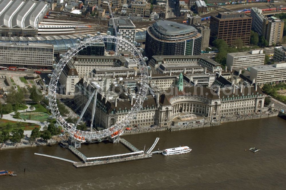 London from the bird's eye view: View the London Eye, also known as Millennium Wheel - a landmark of London. The current tallest Ferris wheel in Europe is the main attraction for tourists from around the world on the banks of the Thames Millennium Pier in front of the building of the London Sea Life Aquarium and Park Gardens Jubiles