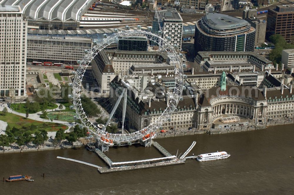 Aerial image London - View the London Eye, also known as Millennium Wheel - a landmark of London. The current tallest Ferris wheel in Europe is the main attraction for tourists from around the world on the banks of the Thames Millennium Pier in front of the building of the London Sea Life Aquarium and Park Gardens Jubiles