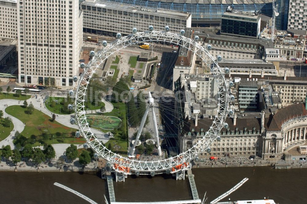 Aerial photograph London - View the London Eye, also known as Millennium Wheel - a landmark of London. The current tallest Ferris wheel in Europe is the main attraction for tourists from around the world on the banks of the Thames Millennium Pier in front of the building of the London Sea Life Aquarium and Park Gardens Jubiles