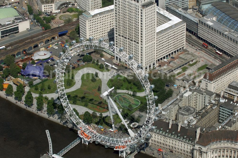 Aerial photograph London - View the London Eye, also known as Millennium Wheel - a landmark of London. The current tallest Ferris wheel in Europe is the main attraction for tourists from around the world on the banks of the Thames Millennium Pier in front of the building of the London Sea Life Aquarium and Park Gardens Jubiles