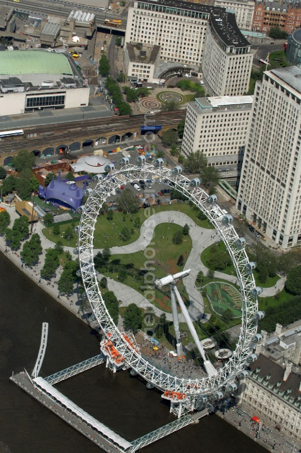 London from above - View the London Eye, also known as Millennium Wheel - a landmark of London. The current tallest Ferris wheel in Europe is the main attraction for tourists from around the world on the banks of the Thames Millennium Pier in front of the building of the London Sea Life Aquarium and Park Gardens Jubiles