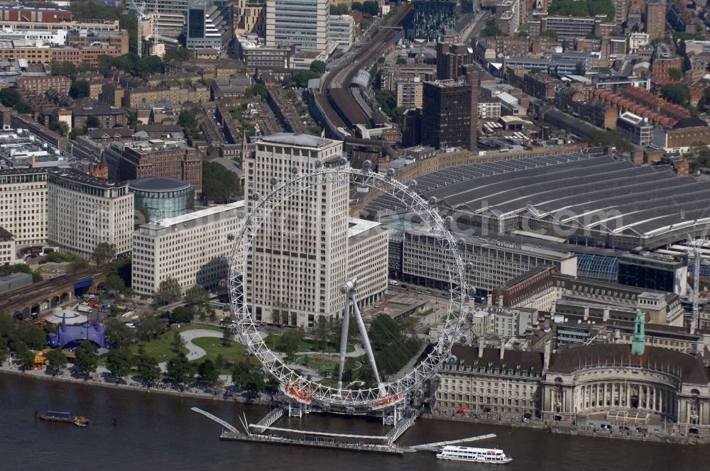 Aerial photograph London - View the London Eye, also known as Millennium Wheel - a landmark of London. The current tallest Ferris wheel in Europe is the main attraction for tourists from around the world on the banks of the Thames Millennium Pier in front of the building of the London Sea Life Aquarium and Park Gardens Jubiles