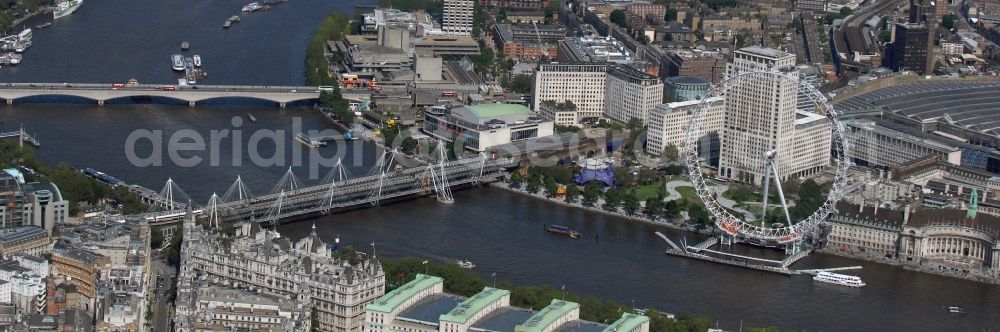 London from above - View the London Eye, also known as Millennium Wheel - a landmark of London. The current tallest Ferris wheel in Europe is the main attraction for tourists from around the world on the banks of the Thames Millennium Pier in front of the building of the London Sea Life Aquarium and Park Gardens Jubiles