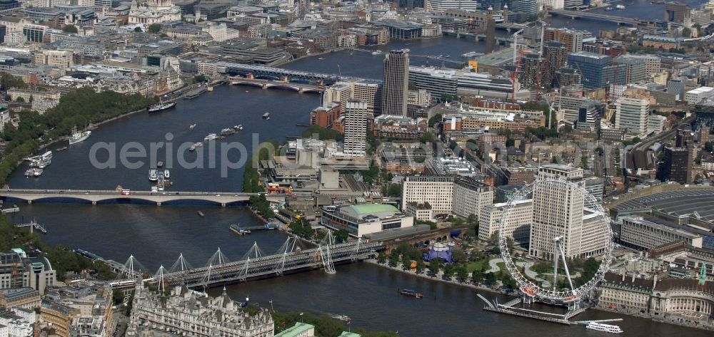 Aerial image London - View the London Eye, also known as Millennium Wheel - a landmark of London. The current tallest Ferris wheel in Europe is the main attraction for tourists from around the world on the banks of the Thames Millennium Pier in front of the building of the London Sea Life Aquarium and Park Gardens Jubiles