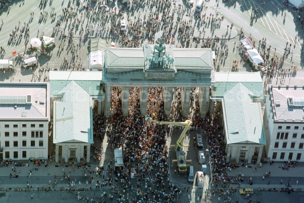 Berlin from above - Participants in the Love Parade music festival on the event concert area on gate Brandenburger Tor in the district Mitte in Berlin, Germany