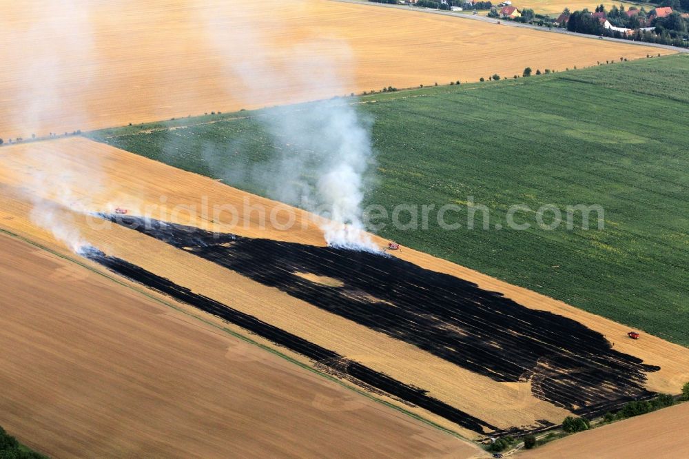 Volkenroda from the bird's eye view: Unloading, the fire on a controlled field - fire on an agricultural property at Volkenroda in Thuringia. Foto: Karina Hessland