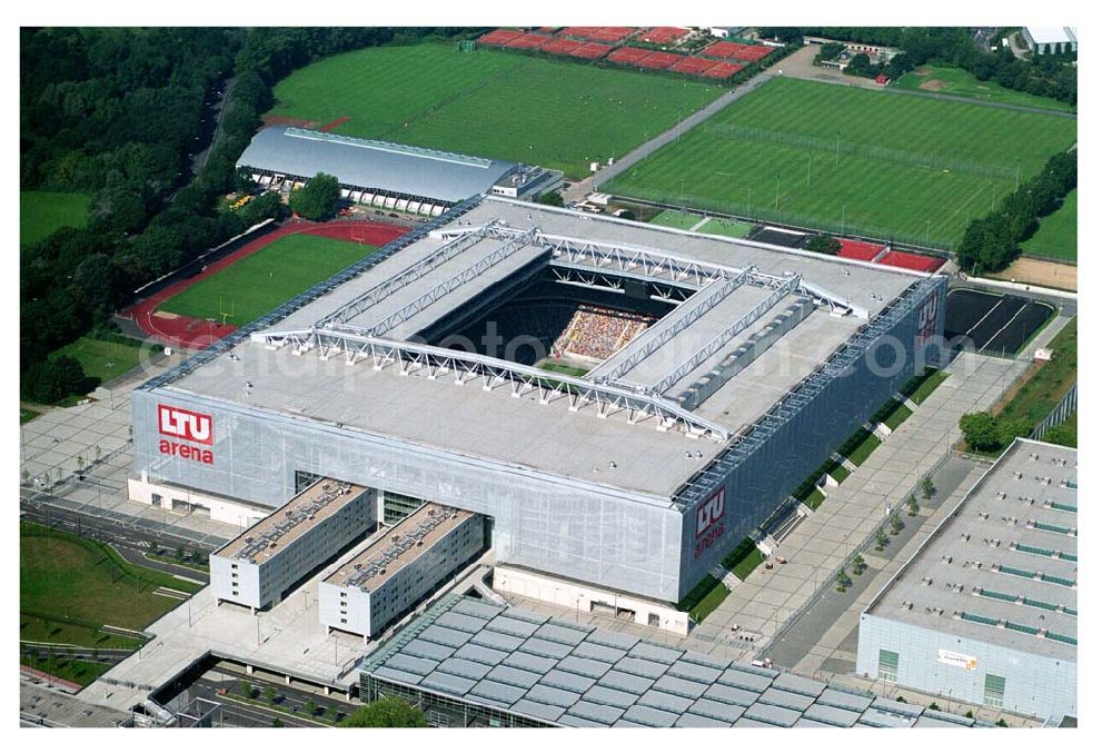 Düsseldorf (NRW) from above - Blick auf die neu erbaubte LTU Arena heute Esprit Arena in Düsseldorf. Die Arena hat ein gigantisches verschließbares Dach, welches komplett 235 Meter lang und 201 Meter breit ist. Insgesamt verfügt die LTU Arena über 51.500 Sitzplätze und bietet bei Musikkonzerten inklusive Innenraum Platz für bis zu 65.000 Zuschauer. LTU arena, MULTIFUNKTIONSARENA DÜSSELDORF BETRIEBS-GMBH, Liesegangstr. 24, 40211 Düsseldorf, +49 (0) 2 11/20 95 47 -10, +49 (0) 2 11/20 95 47 -11, info@duesseldorf-multifunktionsarena.de