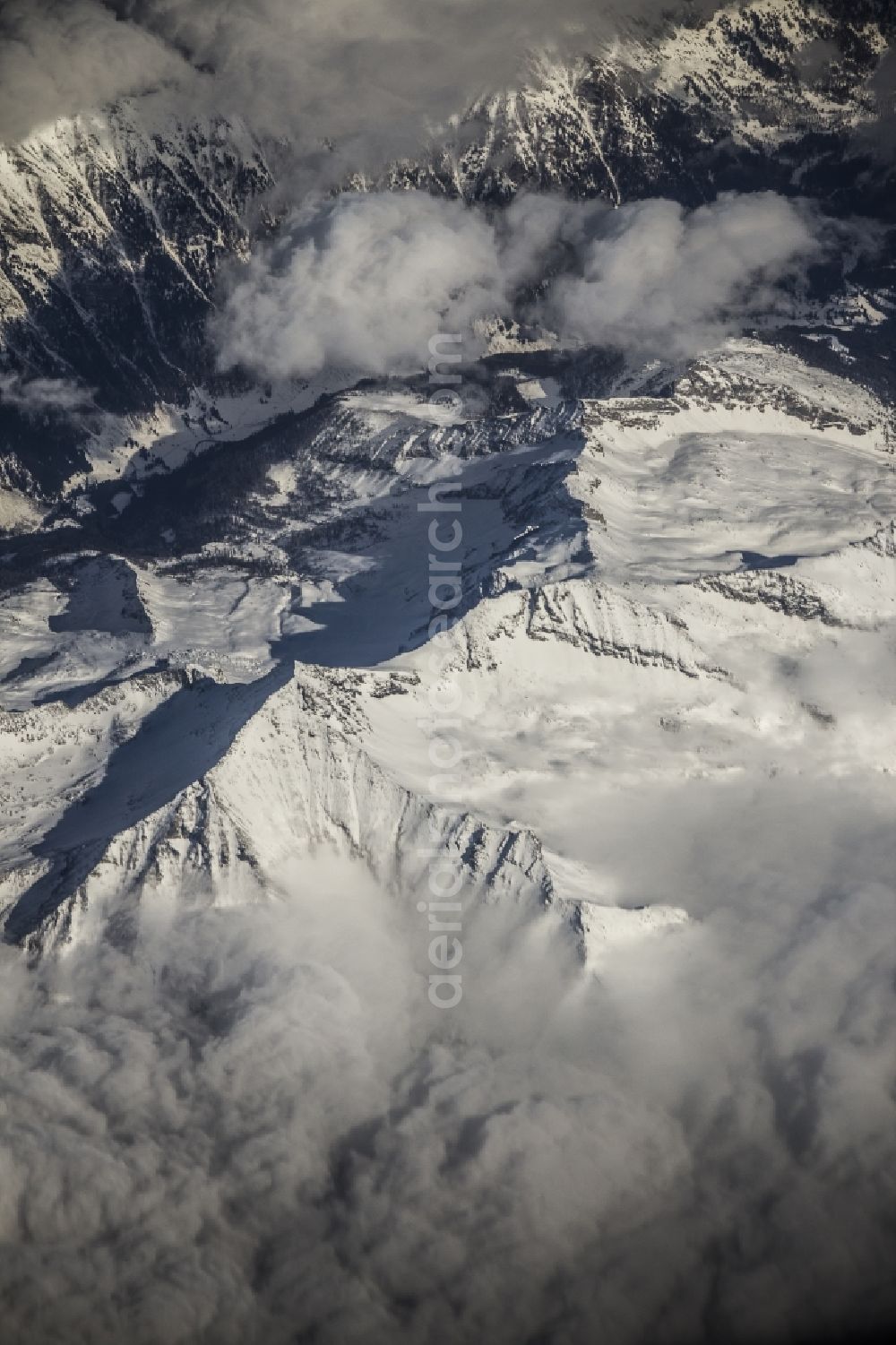 Aerial image Locarno - Luftaufnahme aus 10.000 Meter Höhe vom schneebedeckten Gebirge der Alpen in Locarno in der Schweiz. / Aerial view from 10,000 meters from snow-capped mountains of the Alps in Locarno, Switzerland.