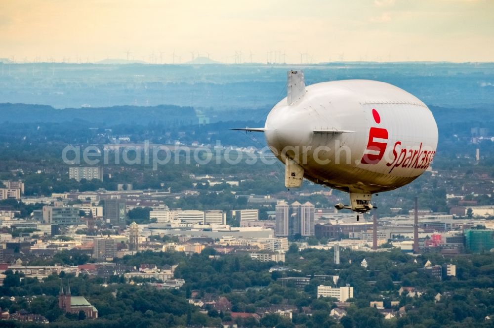 Herne from the bird's eye view: Blimp with Sparkassen- Promotion airship in flight over the airspace in Herne in the state North Rhine-Westphalia