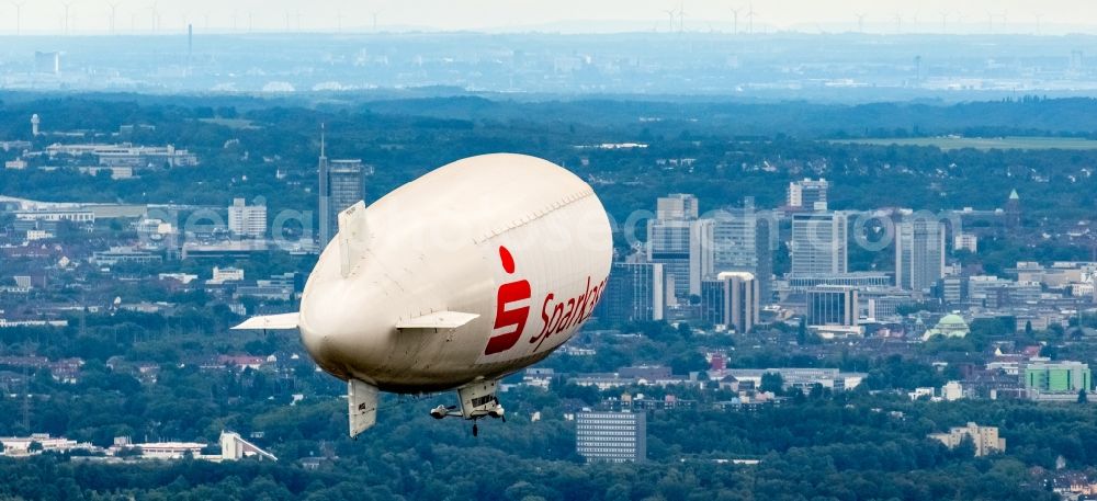 Herne from the bird's eye view: Blimp with Sparkassen- Promotion airship in flight over the airspace in Herne in the state North Rhine-Westphalia