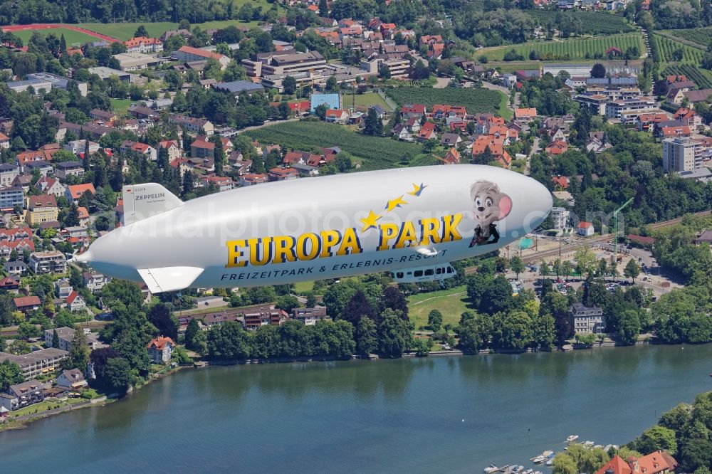 Lindau (Bodensee) from above - Zeppelin NT on the island of Lindau in Bavaria. The semi-rigid airship D-LZFN Friedrichshafen on a tourist flight with passengers