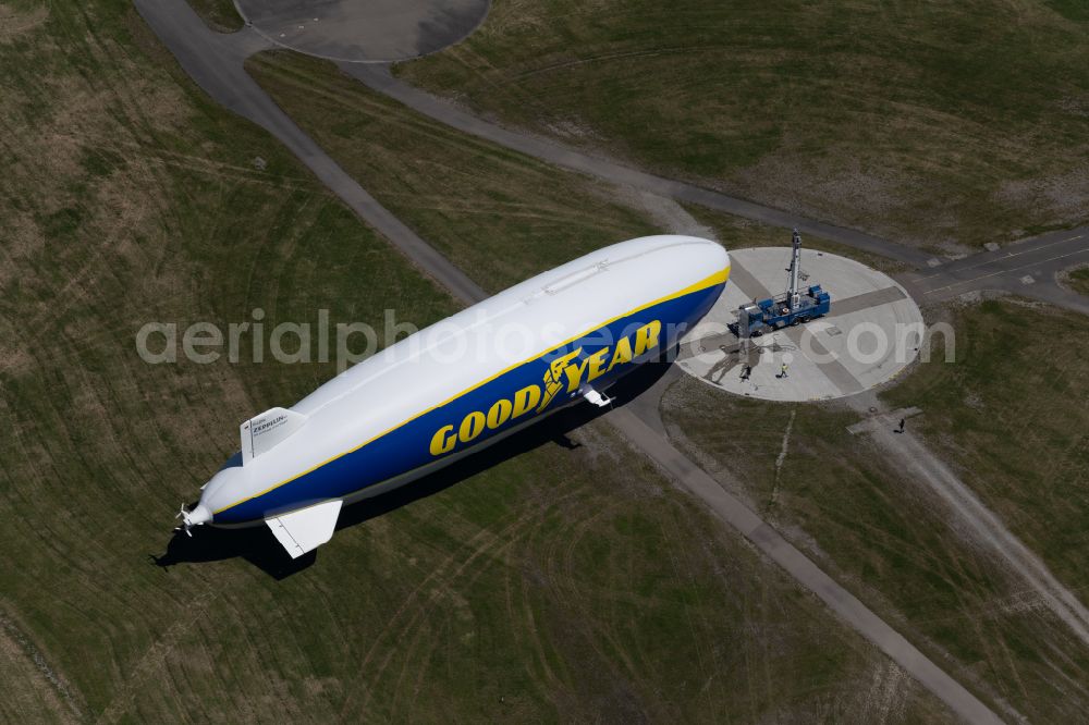 Aerial image Friedrichshafen - Airship Zeppelin NT N07 with the registration D-LZFN of the Deutsche Zeppelin Reederei in flight over the grounds of the airport EDNY in Friedrichshafen in the state Baden-Wuerttemberg, Germany