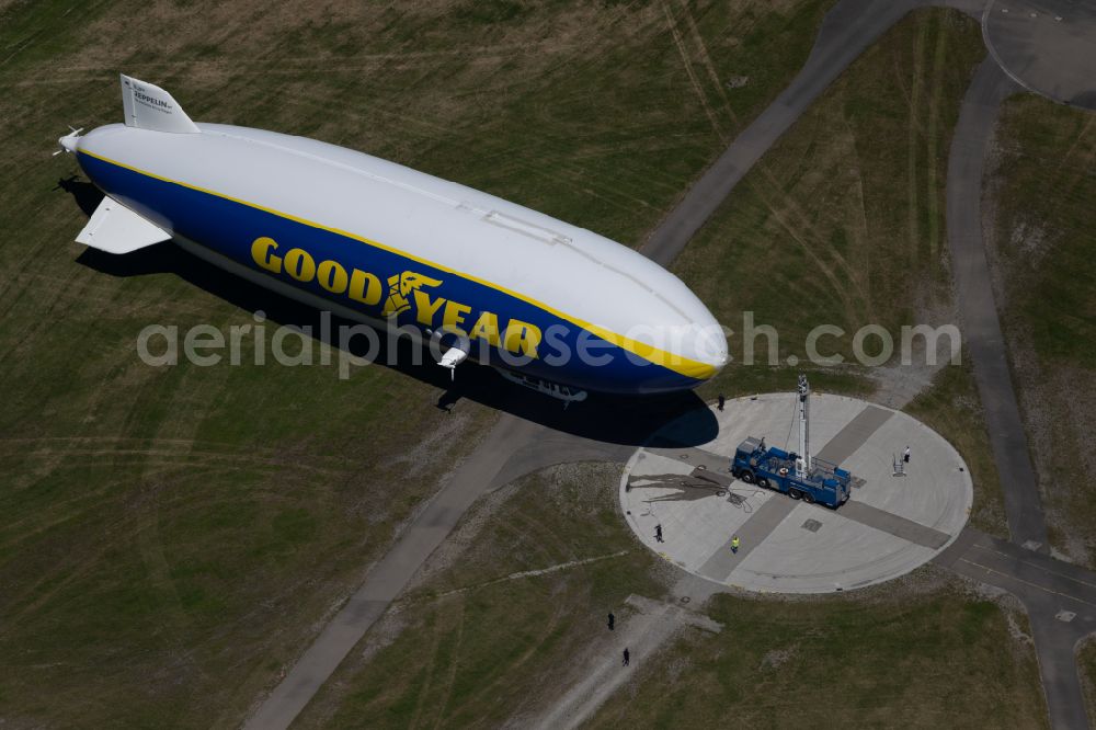 Aerial photograph Friedrichshafen - Airship Zeppelin NT N07 with the registration D-LZFN of the Deutsche Zeppelin Reederei in flight over the grounds of the airport EDNY in Friedrichshafen in the state Baden-Wuerttemberg, Germany