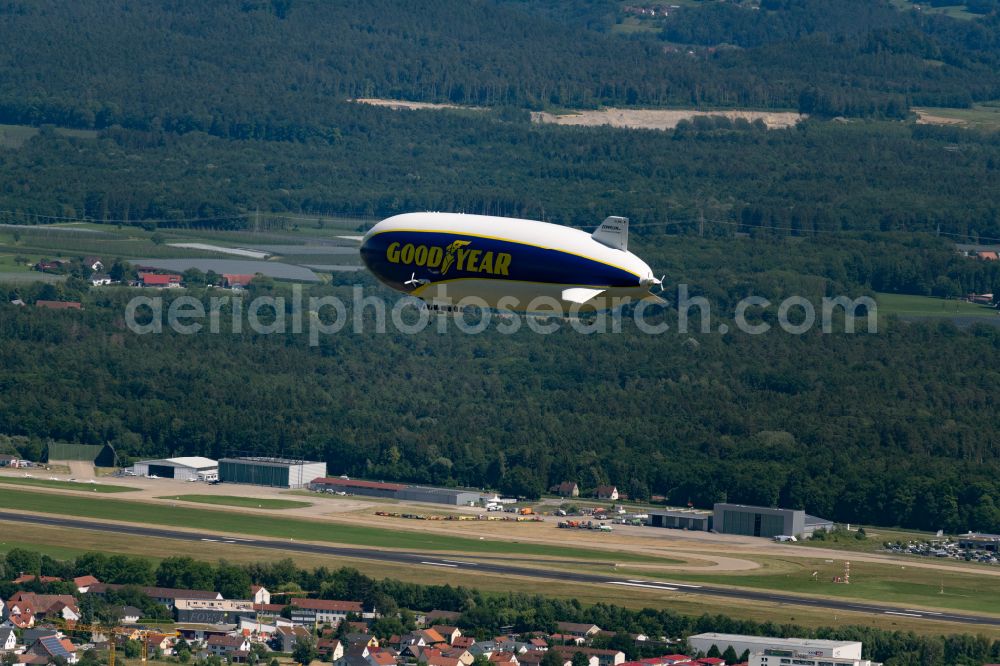 Meckenbeuren from the bird's eye view: Airship Zeppelin NT N07 with the registration D-LZFN of the Deutsche Zeppelin Reederei in flight over the grounds of the airport EDNY in Friedrichshafen in the state Baden-Wuerttemberg, Germany