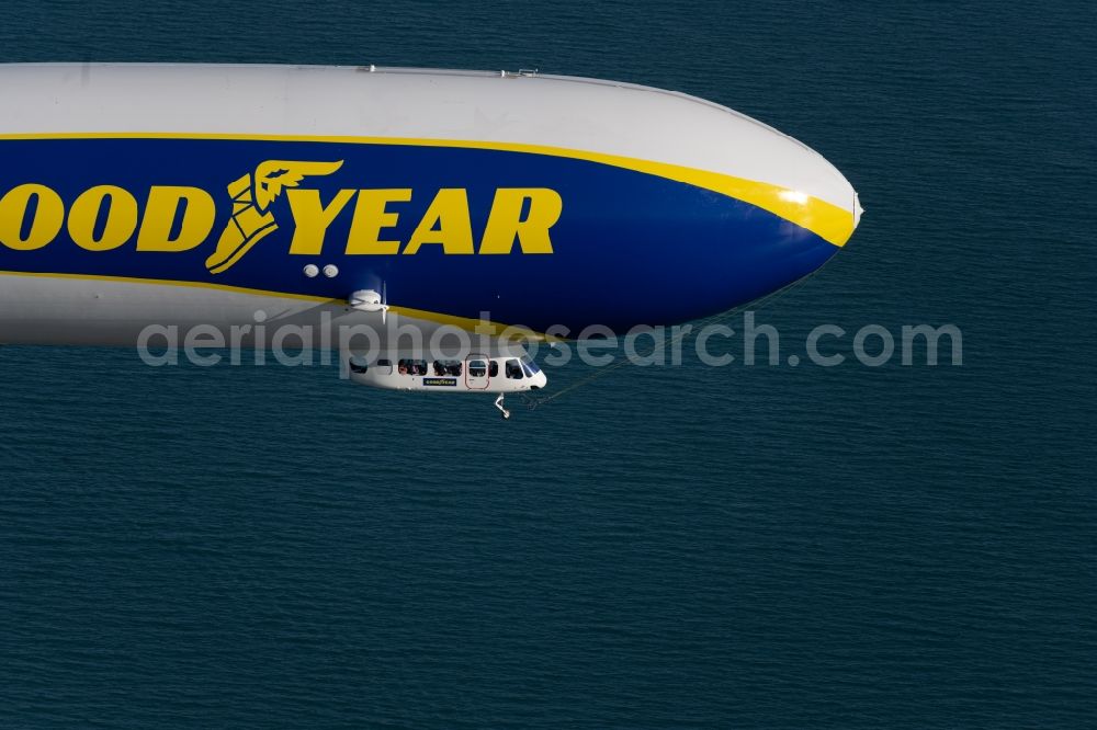 Friedrichshafen from the bird's eye view: Airship Zeppelin NT N07 with the identification D-LZFN of the Deutsche Zeppelin Reederei in flight over the airspace in Friedrichshafen in the state Baden-Wuerttemberg, Germany