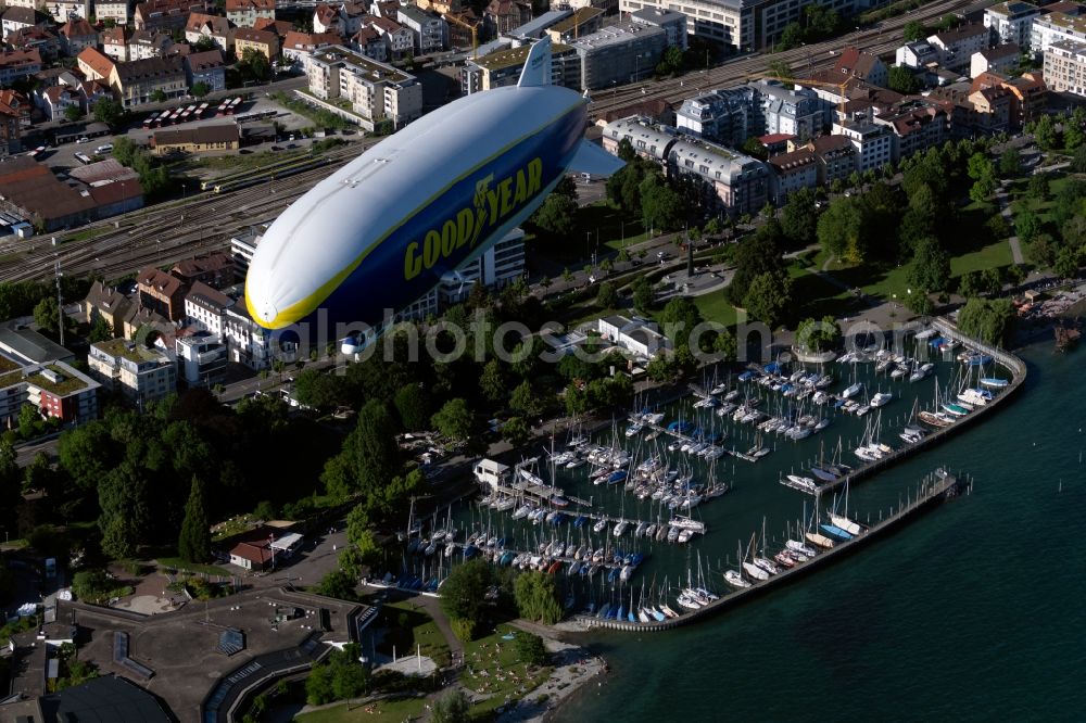 Friedrichshafen from above - Airship Zeppelin NT N07 with the identification D-LZFN of the Deutsche Zeppelin Reederei in flight over the airspace in Friedrichshafen in the state Baden-Wuerttemberg, Germany