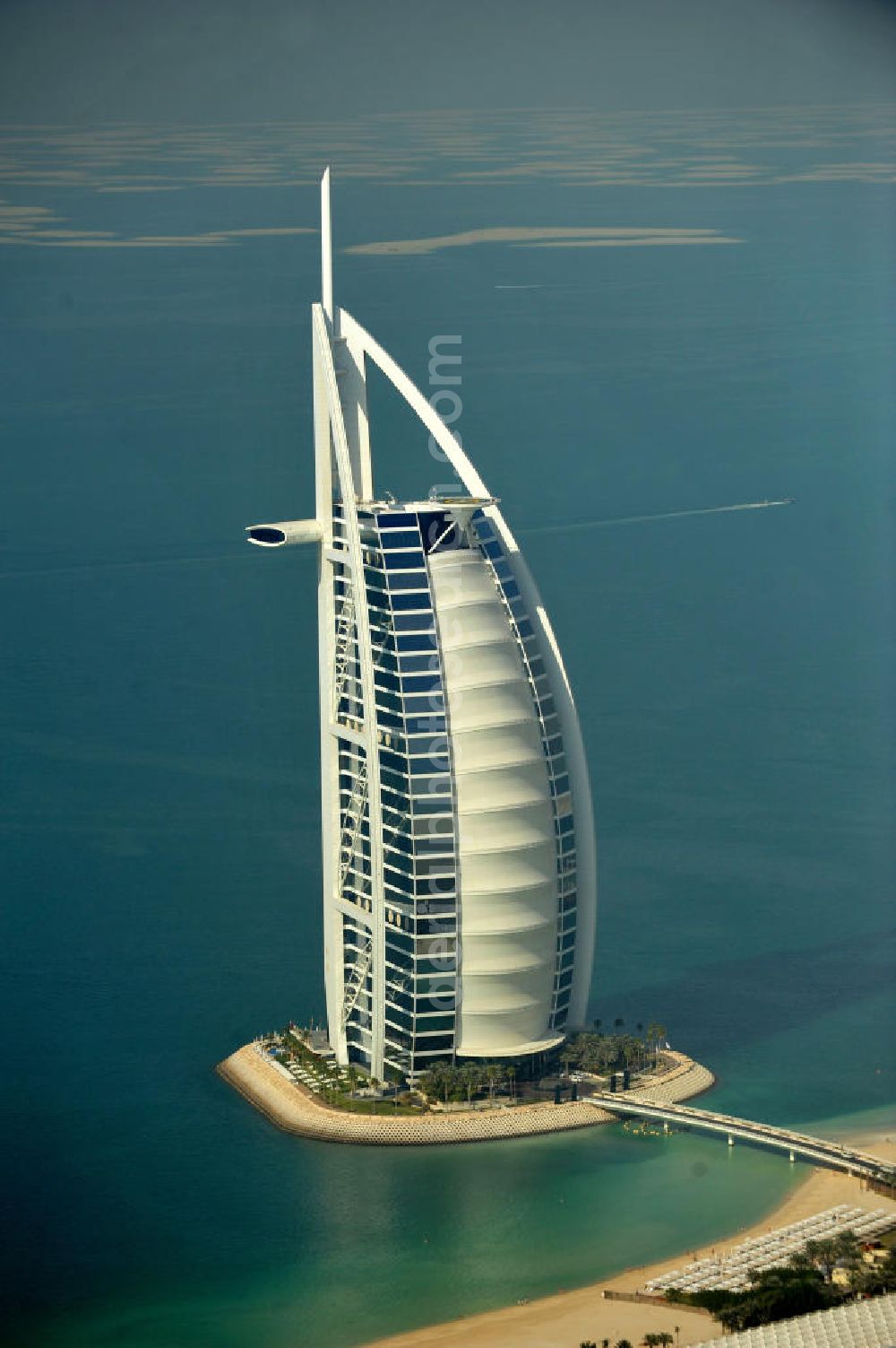 Aerial photograph DUBAI / DUBAYY - Blick auf das Luxus- Hotel Burj al Arab am Persischen Golf in Dubai. Der architektonisch einprägsame Bau der Jumeirah Group ist eines der luxuriösesten und teuersten Hotels der Welt. Mit einer Höhe von 321 Metern ist es nach dem Rose Tower das höchste reine Hotelgebäude der Welt und ein Wahrzeichen der emiratischen Stadt Dubai. Der Entwurf stammt von Tom Wright / Atkins Middle East. Ausdrücklicher Wunsch der Bauherren war es, eine Architekturikone zu schaffen, die ein Identifikationsmerkmal für Dubai wird. Der Entwurf hat die Form des Segels einer modernen Yacht und soll die Vergangenheit als Seehandelszentrum sowie die Zukunftsorientierung Dubais symbolisieren. Luxury hotel Burj al Arab on Persian Gulf in Dubai.