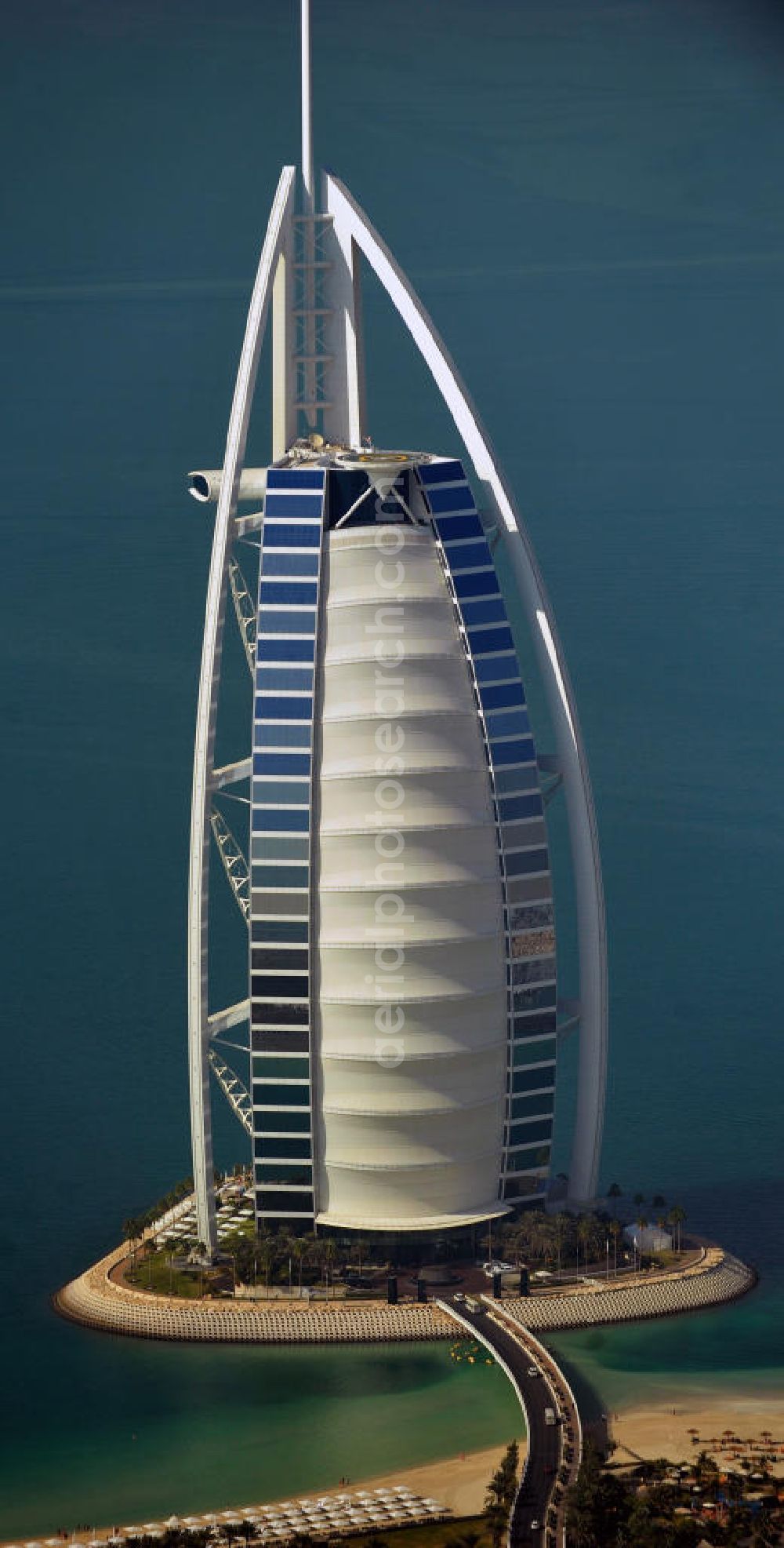 Aerial photograph DUBAI / DUBAYY - Blick auf das Luxus- Hotel Burj al Arab am Persischen Golf in Dubai. Der architektonisch einprägsame Bau der Jumeirah Group ist eines der luxuriösesten und teuersten Hotels der Welt. Mit einer Höhe von 321 Metern ist es nach dem Rose Tower das höchste reine Hotelgebäude der Welt und ein Wahrzeichen der emiratischen Stadt Dubai. Der Entwurf stammt von Tom Wright / Atkins Middle East. Ausdrücklicher Wunsch der Bauherren war es, eine Architekturikone zu schaffen, die ein Identifikationsmerkmal für Dubai wird. Der Entwurf hat die Form des Segels einer modernen Yacht und soll die Vergangenheit als Seehandelszentrum sowie die Zukunftsorientierung Dubais symbolisieren. Luxury hotel Burj al Arab on Persian Gulf in Dubai.