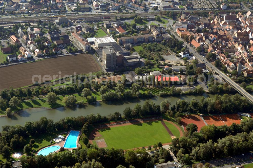 Aerial photograph Ochsenfurt - Blick aus Norden über den Uferbereich mit Sportstätte und Freibad auf der Maininsel am Main auf das Industriegebiet Ochsenfurt.