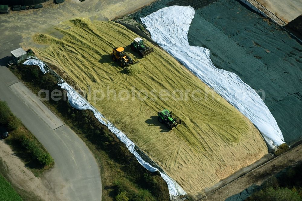 Aerial photograph Edemissen - Maize crop on a grain storage and storage area of an agricultural in Edemissen in the state Lower Saxony