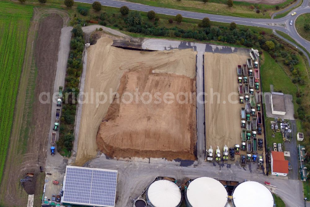 Rosdorf from above - Maize crop on a grain storage and storage area of an agricultural in Rosdorf in the state Lower Saxony, Germany