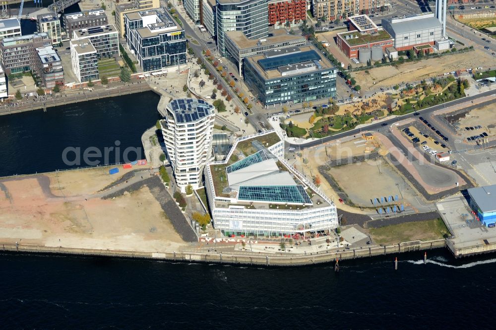 Hamburg from the bird's eye view: View of the Marco-Polo-Tower and the German headquarters of Unilever in the HafenCity of Hamburg. The 2009 and 2010 completed buildings are the first of many projects at the Strandkai, a partial area of the HafenCity and were designed by the architects Behnisch Architekten